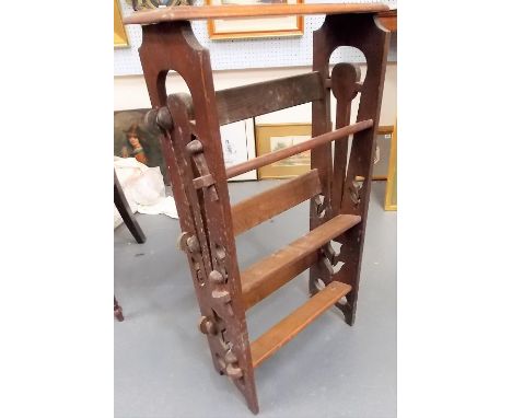 Early 20th Century oak low Arts and Crafts three-tier book trough of pin construction and with pierced supports, width 46cm