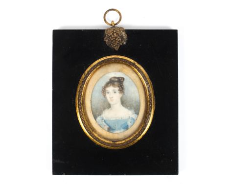 An early 19th century portrait miniature of a lady in blue silk dress, watercolour on ivory, in gilt-metal mounted ebonised f