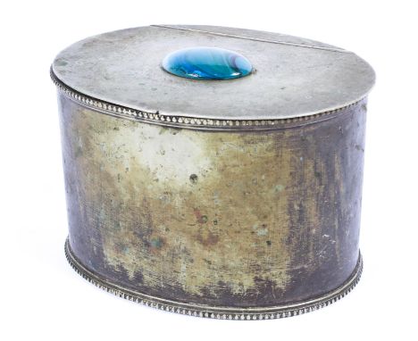 A white metal Arts and Crafts style oval tea caddy, the lid mounted with an oval blue glass marbled cabochon, with beeded bor