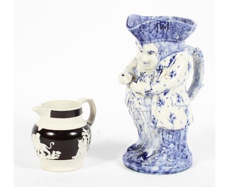 A Victorian stoneware jug and a pottery toby jug, the jug moulded with classical figures and a putti on a dark brown dipped g