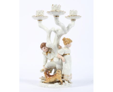 A Royal Worcester three light figural candleabra modelled by James Hadley, late 19th century, printed puce and impressed mark