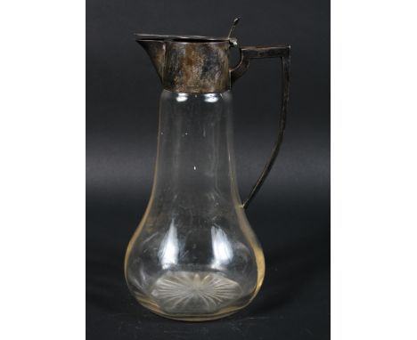 An early 20th century silver mounted glass claret jug, the base with star cut decoration, hallmarks rubbed but appear to read