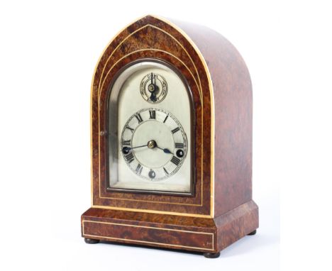 A German (Winterhalder &amp; Hofmeier) chiming burr walnut mantle clock, early 20th century, of arched form with silver dial 
