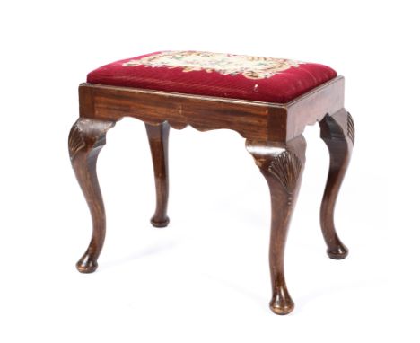 A Georgian mahogany needlework stool, the seat decorated with a floral design on a red ground, supported on cabriole legs, 46