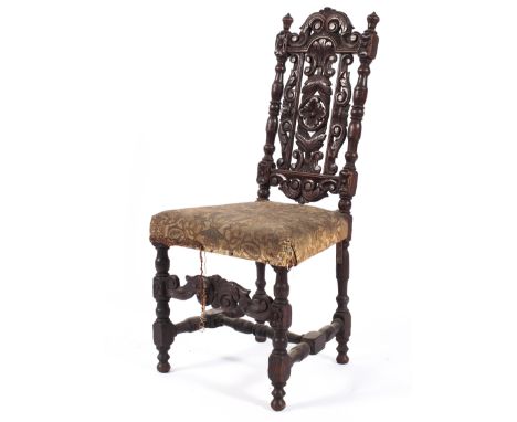 A Carolean style carved oak child's chair, early 20th century, the tall back carved with scrolls and flowers between turned b