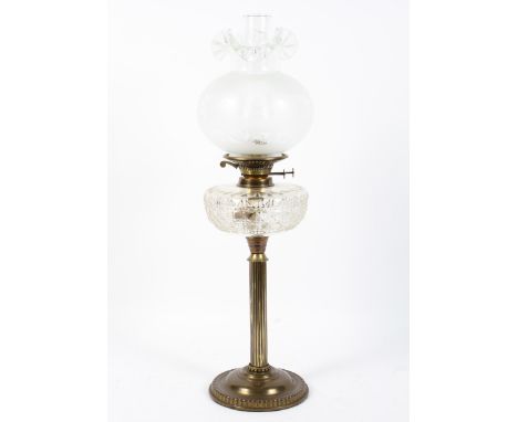 A 20th century brass table lamp, the column support on a circular base, with a moulded glass reservoir, a glass funnel and a 