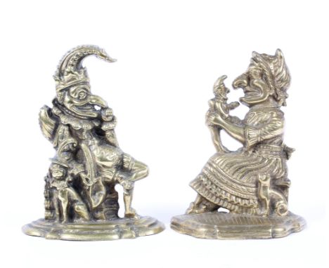 A pair of early 20th century Punch &amp; Judy heavy brass doorstop figures, with Punch sat beside a small dog, Judy holding a