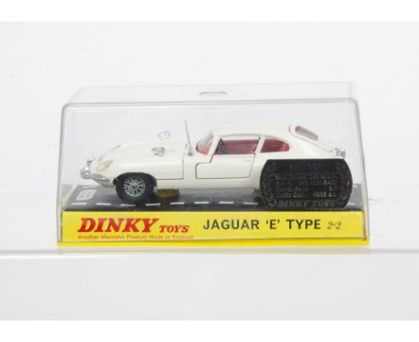 A Dinky Toys 131 Jaguar E Type 2+2, white body, red interior, gold base, cast spoked wheels, in original hard plastic case, E