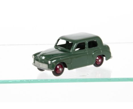 A Dinky Toys 40f Hillman Minx, rare dark green body, maroon hubs, small baseplate lettering, VG