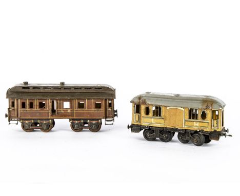 Early O Gauge Continental-style bogie Coaching Stock, both in shades of lithographed wood-grain finish, the larger probably b
