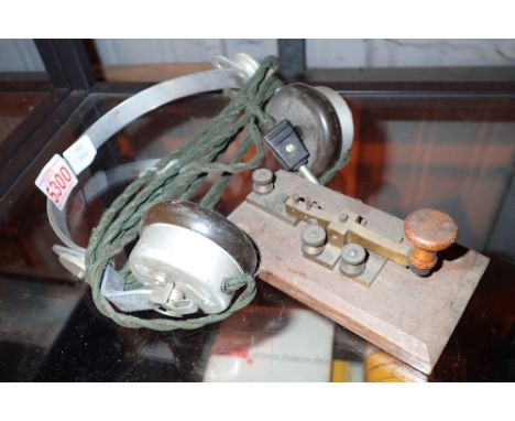 Antique morse code key and a pair of vintage headphones 