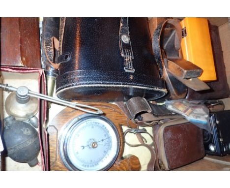 Box of collectables including vintage cameras Optimax binoculars leather shot flask and a barometer 