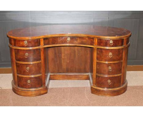 WALNUT CROSSBANDED KIDNEY SHAPED WRITING DESK OF GEORGE III DESIGN 
with three frieze drawers with three drawers to each pede