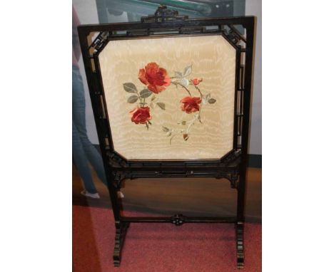 LATE VICTORIAN EBONISED FIRE SCREEN
with Anglo-Japanese influenced lattice work frame, the glazed cream silk screen embroider