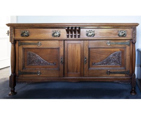 MAHOGANY SIDEBOARD OF ARTS & CRAFTS DESIGN 
with two frieze drawers, cupboard below enclosed by two carved and moulded panel 