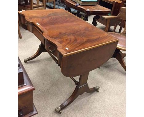 MAHOGANY CROSSBANDED SOFA TABLE OF REGENCY DESIGN
the serpentine shaped front fitted three frieze drawers, on trestle end sup