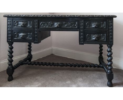 VICTORIAN STAINED AND CARVED OAK WRITING DESK OF 17TH CENTURY DESIGN 
the top inset tooled leather writing surface, with cent