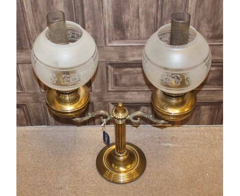BRASS DOUBLE OIL LAMP
with two cast scrolling branches issuing from the central reeded column, with part frosted glass globul