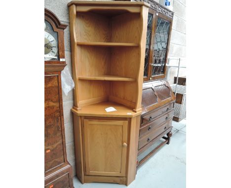A modern corner cupboard and shelf unit in an Ercol design