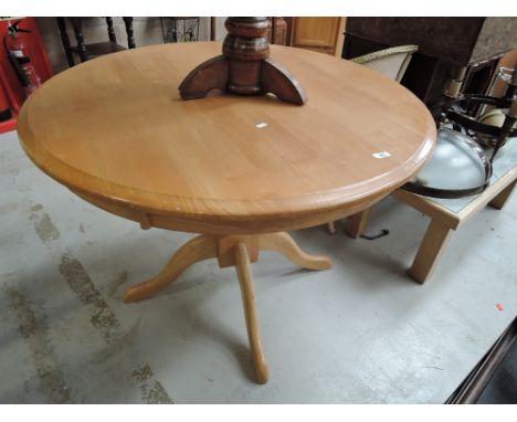 A modern beech circular dining table