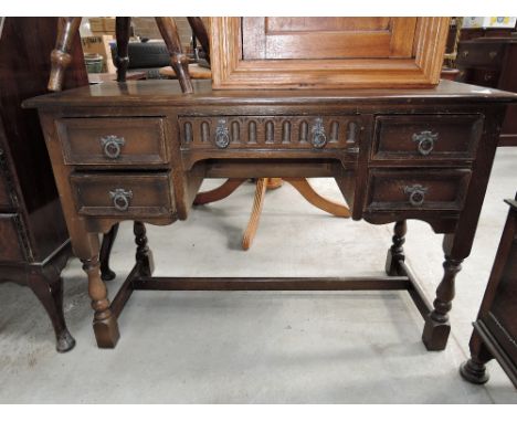 A traditional dark stained priory style dressing table