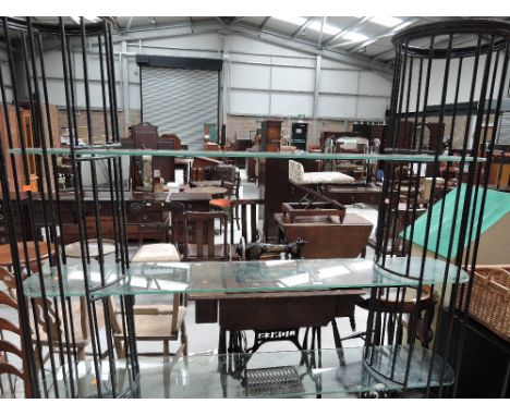 A large wrought iron and glass shelf unit