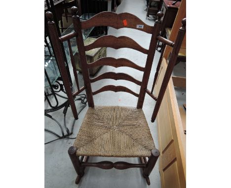 A 19th Century oak frame ladder back woolwinder rocking chair
