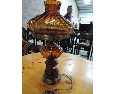 An amber glass ouil lamp style electric table lamp