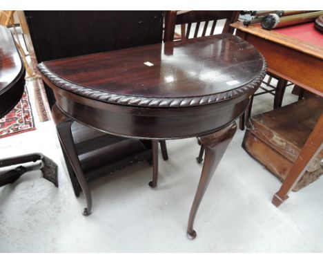 A reproduction demi lune hall table