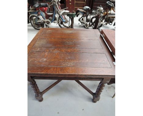 An early 20th Century oak twist leg drawer leaf table