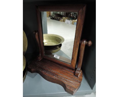 A vintage mahogany toilet or bathroom mirror