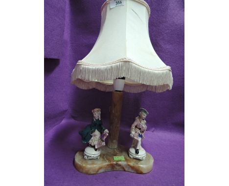 A vintage lamp with figural base