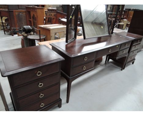 A stag dressing table and two stag bedside drawers