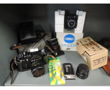 A selection of vintage photography and camera equipment including 12 xp zenit camera and boxed Minolta AFT