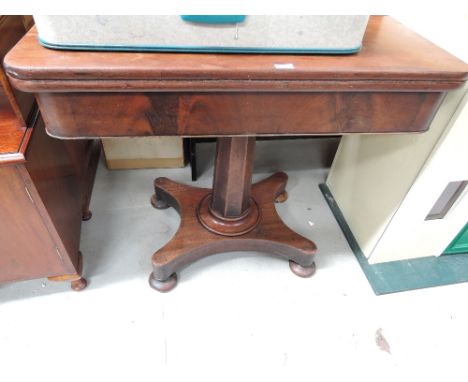 An antique mahogany swivel top tea table 