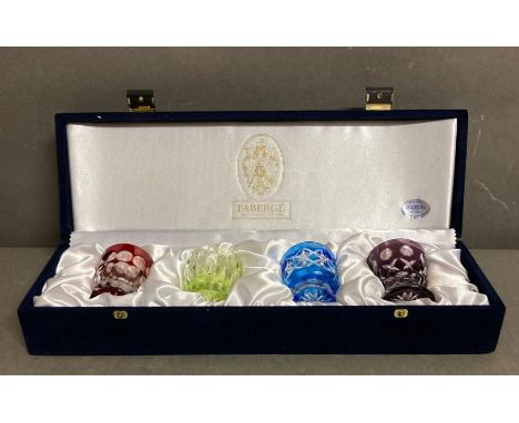 A velvet cased set of four Faberge coloured crystal vodka shot glasses 