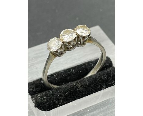 A Platinum set three stone diamond ring. Size Q 