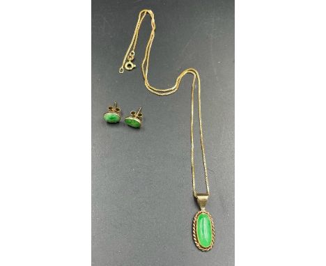 A 9ct gold jade pendant and earrings.