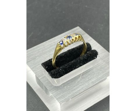 A sapphire and diamond ring with alternating stones on an untested gold setting. Size R