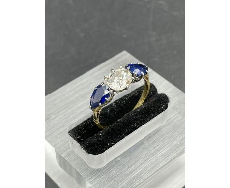 A Diamond and sapphire ring on an 18ct yellow gold setting (Central stone 6mm x 5mm) Size L
