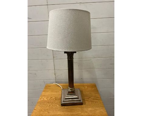  A white metal Corinthian column table lamp with swags and ram head corners to base 