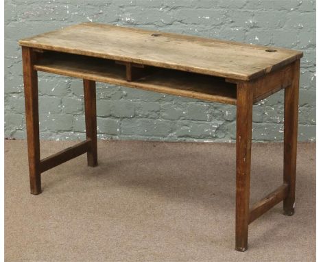 An oak school desk raised on tapering square supports with under desk shelf, 101.25cm width, 41.75cm depth&nbsp;, 63.75cm hei