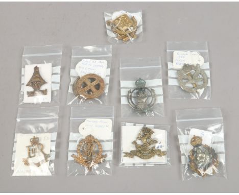 Eleven military cap badges including Royal Army Ordnance Corps, Military Police, Queens own Worcestershire Hussars, Glider Pi