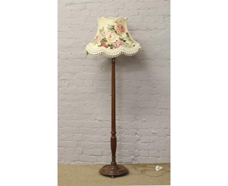 A mahogany standard lamp with reeded column and floral shade.