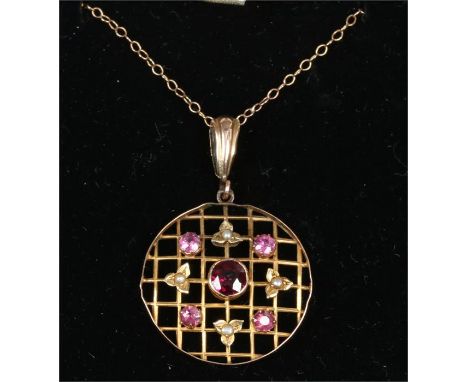 A 9ct gold ruby garnet and pearl circular trellis pendant on chain.