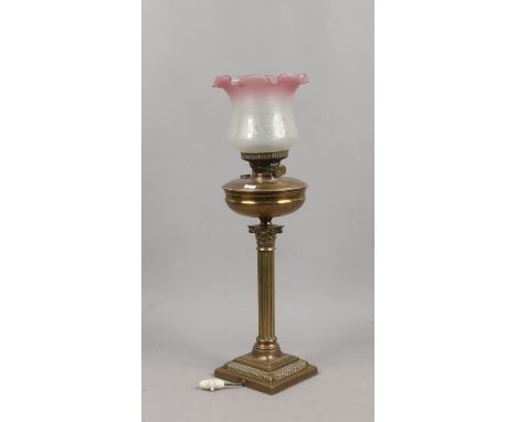 A tablelamp formed as an oil lamp with reeded column and coloured glass shade.