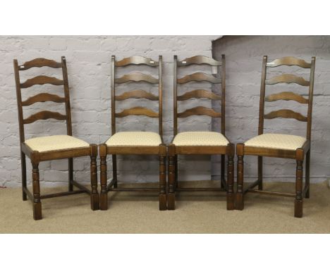 A set of four ladder back dining chairs, raised on turned and square supports.