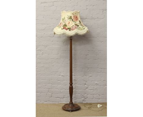 A carved and reeded oak standard lamp and shade.