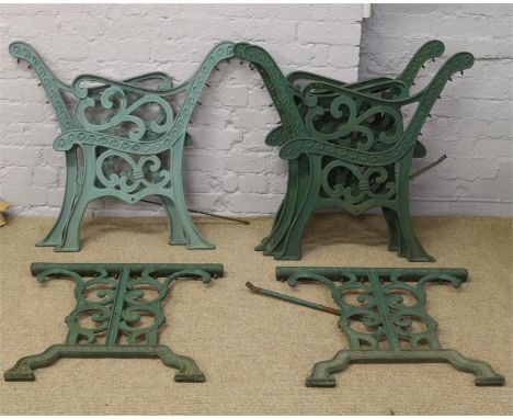 Three pairs of painted cast iron bench ends and a pair of cast iron table ends.