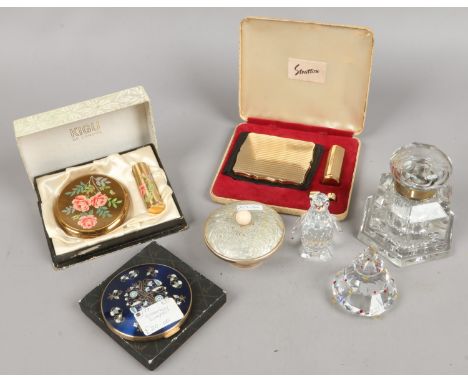 A glass inkwell, Russian enamel powderbowl, three boxed compacts including Stratton and two Swarovski models one of a penguin